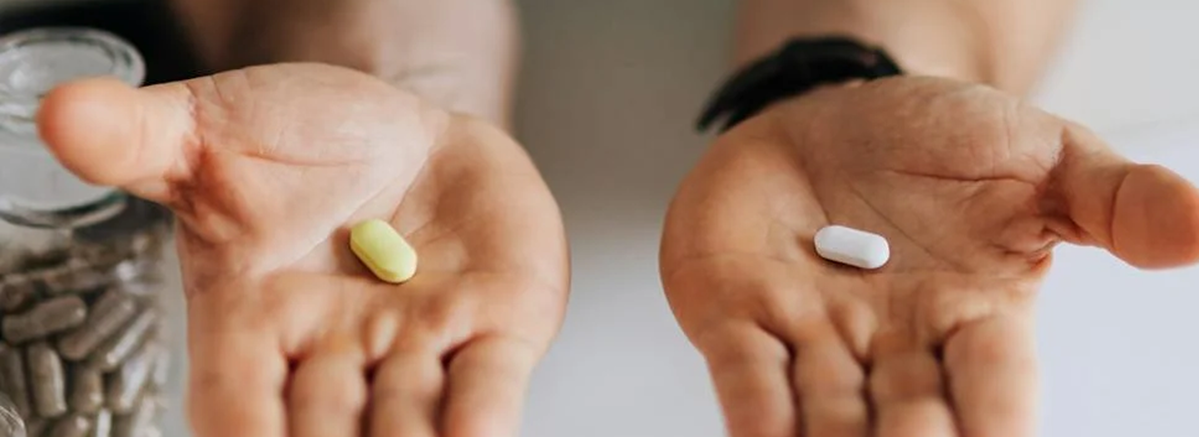 A healthcare professional presenting two pills, highlighting their role in medical therapy.