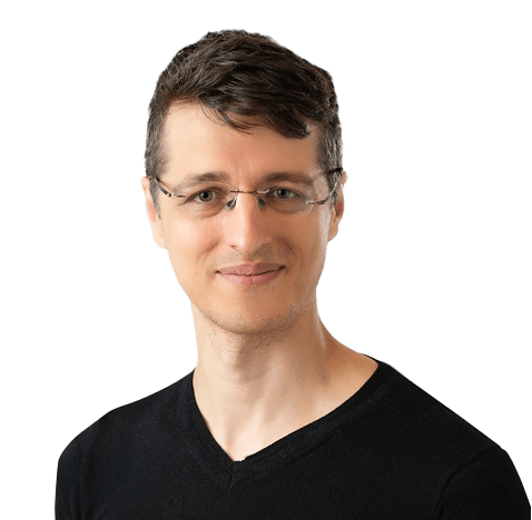 A man wearing glasses and a black shirt, looking directly at the camera with a neutral expression.