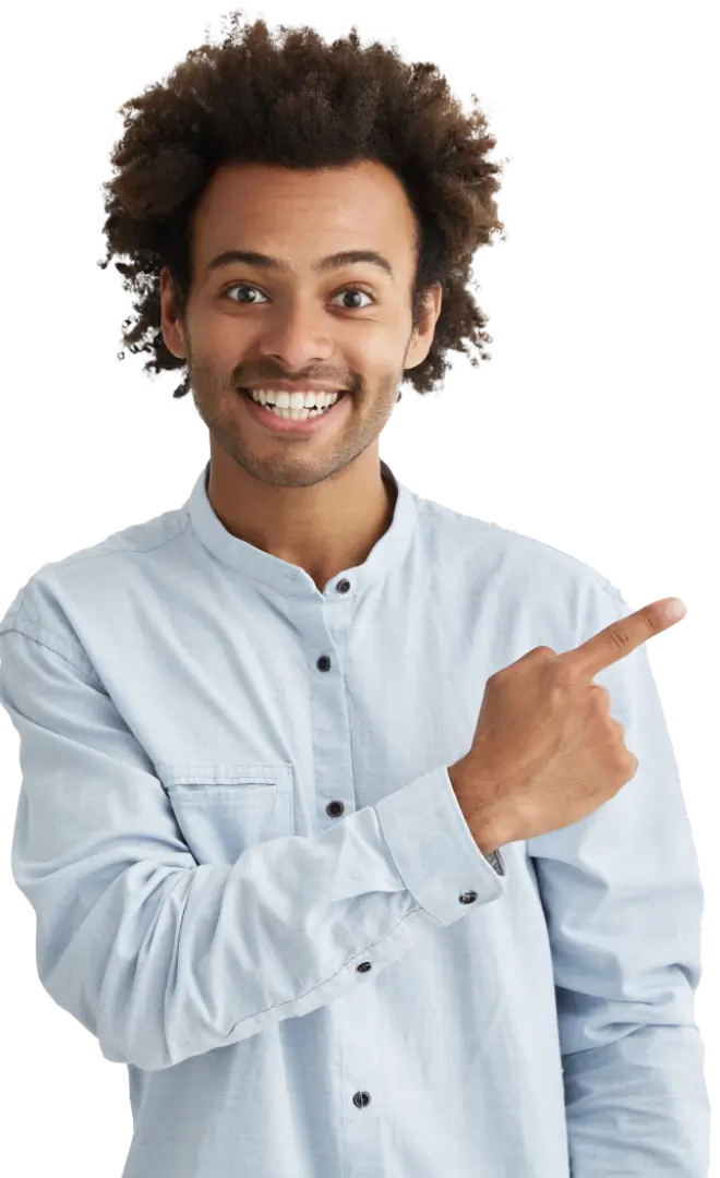 A man with curly hair gestures towards an object, indicating interest or emphasis in a conversation.