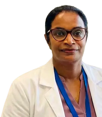 A woman wearing a lab coat and glasses, standing in a laboratory setting, focused on her work.